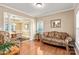 Cozy living room featuring hardwood floors, columns, and a view into the adjacent dining room at 100 Oakwood Meadow Dr, Mooresville, NC 28115