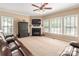 Comfortable living room with fireplace and large windows with lots of natural light at 100 Oakwood Meadow Dr, Mooresville, NC 28115