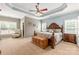 Spacious main bedroom with a decorative ceiling, ceiling fan and carpet flooring at 100 Oakwood Meadow Dr, Mooresville, NC 28115