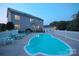 Backyard view showcasing a private pool, poolside seating, and a fenced yard for outdoor enjoyment at 100 Oakwood Meadow Dr, Mooresville, NC 28115