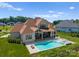 Aerial view showcasing a beautiful home, pool, spa, lush landscaping, and outdoor living spaces at 10201 Laurier Ln, Huntersville, NC 28078