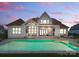 A house with a large backyard pool, a patio, and big open windows to view the outside in at 10201 Laurier Ln, Huntersville, NC 28078