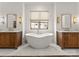 Bright bathroom with a free standing tub and double vanity with gorgeous fixtures at 10201 Laurier Ln, Huntersville, NC 28078