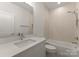 Well lit bathroom with a soaking tub, shower, and sleek vanity with a modern sink and large mirror at 10201 Laurier Ln, Huntersville, NC 28078