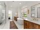 Bright bathroom with a free standing tub, double vanity with gorgeous fixtures, and a glass-enclosed shower at 10201 Laurier Ln, Huntersville, NC 28078