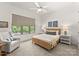Comfortable bedroom with neutral colors and natural light; includes window with backyard view at 10201 Laurier Ln, Huntersville, NC 28078
