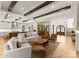 Open-concept living space with a kitchen, living room, wine cellar, and exposed wood beams at 10201 Laurier Ln, Huntersville, NC 28078