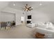 Spacious living room featuring a large white sofa, a ceiling fan, and a bar area with a sink and mini-fridge at 10201 Laurier Ln, Huntersville, NC 28078