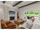 Comfortable living room featuring a fireplace, TV, sliding glass doors to outdoor spaces at 10201 Laurier Ln, Huntersville, NC 28078