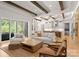 Spacious living room featuring wooden beams, hardwood floors, and an open concept design with lots of natural light at 10201 Laurier Ln, Huntersville, NC 28078