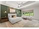 Beautiful bedroom featuring a decorative wall, a ceiling fan, and plenty of natural light at 10201 Laurier Ln, Huntersville, NC 28078
