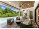 Relaxing outdoor patio overlooking a pool, with comfortable seating, and a built-in outdoor kitchen at 10201 Laurier Ln, Huntersville, NC 28078