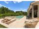 Luxurious backyard with a swimming pool, spa, lounge chairs, and outdoor seating area, perfect for relaxation at 10201 Laurier Ln, Huntersville, NC 28078