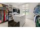 Spacious walk-in closet with custom shelving, drawers, and a central island for ample storage at 10201 Laurier Ln, Huntersville, NC 28078