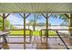 Lake views from a covered back porch with an outdoor dining area and a hammock at 1077 Jackson Rd, Fort Lawn, SC 29714