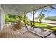 Spacious covered back porch with lake views, an outdoor dining area and a hammock at 1077 Jackson Rd, Fort Lawn, SC 29714