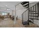 Open basement showcasing a black spiral staircase leading up from a partially finished living area with wood floors at 1077 Jackson Rd, Fort Lawn, SC 29714