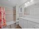 Bright bathroom features shower with neutral tile, white vanity with marble counter, and wood-look flooring at 1077 Jackson Rd, Fort Lawn, SC 29714
