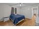 Bright bedroom featuring a plush blue bedspread and a ceiling fan, complemented by wood flooring at 1077 Jackson Rd, Fort Lawn, SC 29714