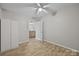 Bright bedroom with wooden floors, a wardrobe, and open entry to another room at 1077 Jackson Rd, Fort Lawn, SC 29714