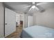 Bright bedroom with a ceiling fan, wooden floors, and access to the dining room at 1077 Jackson Rd, Fort Lawn, SC 29714