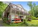 Charming home featuring a large wooden deck, exterior storage, and serene surroundings at 1077 Jackson Rd, Fort Lawn, SC 29714