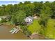 Aerial view of waterfront home featuring a private dock and sprawling lawn surrounded by lush trees at 1077 Jackson Rd, Fort Lawn, SC 29714