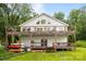 Spacious home showcasing a large wooden deck, boat storage, and serene surroundings at 1077 Jackson Rd, Fort Lawn, SC 29714