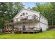 Picturesque home featuring a large wooden deck with water views and ample storage space at 1077 Jackson Rd, Fort Lawn, SC 29714