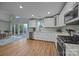 Bright kitchen with white cabinetry, stainless steel appliances, and hardwood floors at 1077 Jackson Rd, Fort Lawn, SC 29714