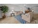 Inviting living room features cozy furniture, area rug, and views into the dining area at 1077 Jackson Rd, Fort Lawn, SC 29714