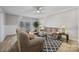Spacious living room with comfortable sofas, a ceiling fan, and a view of the backyard through sliding glass doors at 1077 Jackson Rd, Fort Lawn, SC 29714