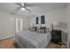 Comfortable bedroom featuring wood floors, neutral tones, and a glimpse of the ensuite bathroom at 1077 Jackson Rd, Fort Lawn, SC 29714