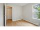 Light bedroom featuring window, closet, wood-look floors, and neutral color scheme at 1162 Willet Dr, Rock Hill, SC 29732