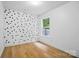 Bright bedroom with light hardwood floors, white walls, and a window offering natural light at 1162 Willet Dr, Rock Hill, SC 29732