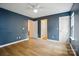 Spacious blue bedroom showcasing hardwood floors and multiple doors for easy access at 1162 Willet Dr, Rock Hill, SC 29732