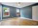 Bedroom with ceiling fan, blue accent wall, and abundant natural light from two windows at 1162 Willet Dr, Rock Hill, SC 29732