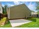 The rear exterior of this home has neutral siding, an air conditioning unit, and a small concrete patio at 1162 Willet Dr, Rock Hill, SC 29732