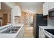 Charming kitchen featuring modern appliances, floral wallpaper, and wood-look flooring at 1162 Willet Dr, Rock Hill, SC 29732