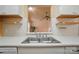 Kitchen sink under window with view to the living room, complete with open shelving at 1162 Willet Dr, Rock Hill, SC 29732