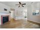 Open-concept living room with a fireplace, modern shelving, and new flooring at 1162 Willet Dr, Rock Hill, SC 29732