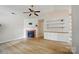 Spacious living room featuring a cozy fireplace, modern shelving, and hardwood floors at 1162 Willet Dr, Rock Hill, SC 29732