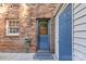 Brick backyard with blue doors, string lights, and greenery at 1228 Archdale Dr # H, Charlotte, NC 28217