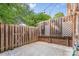 Fenced backyard with patio featuring a dartboard and string lights at 1228 Archdale Dr # H, Charlotte, NC 28217