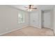 Neutral bedroom featuring carpet, ceiling fan, and window at 1228 Archdale Dr # H, Charlotte, NC 28217