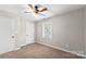 Neutral bedroom featuring carpet, ceiling fan, and window at 1228 Archdale Dr # H, Charlotte, NC 28217