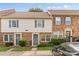 Charming townhouse with brick and siding exterior, featuring blue shutters and well-maintained landscaping at 1228 Archdale Dr # H, Charlotte, NC 28217