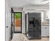 Efficient kitchen with stainless steel refrigerator, white cabinets, and access to the backyard at 1228 Archdale Dr # H, Charlotte, NC 28217