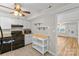 Kitchen with black appliances, white cabinets, and an adjacent room at 1228 Archdale Dr # H, Charlotte, NC 28217