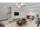 A bright living room with hardwood floors, modern furniture, and a ceiling fan at 1228 Archdale Dr # H, Charlotte, NC 28217
